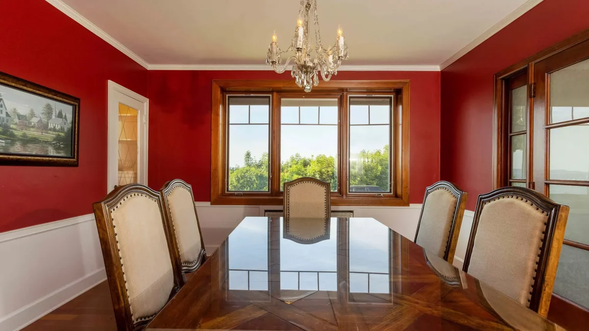 A red dining room with table and chairs.