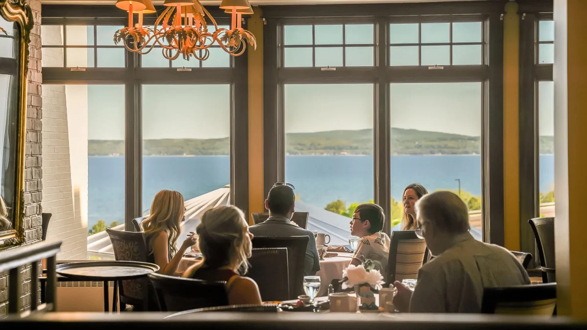 people at dinner at a restaurant lakeside.