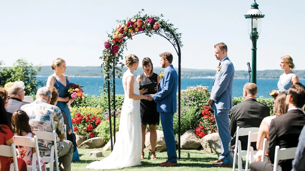 Bride and groom at wedding ceremony with family.